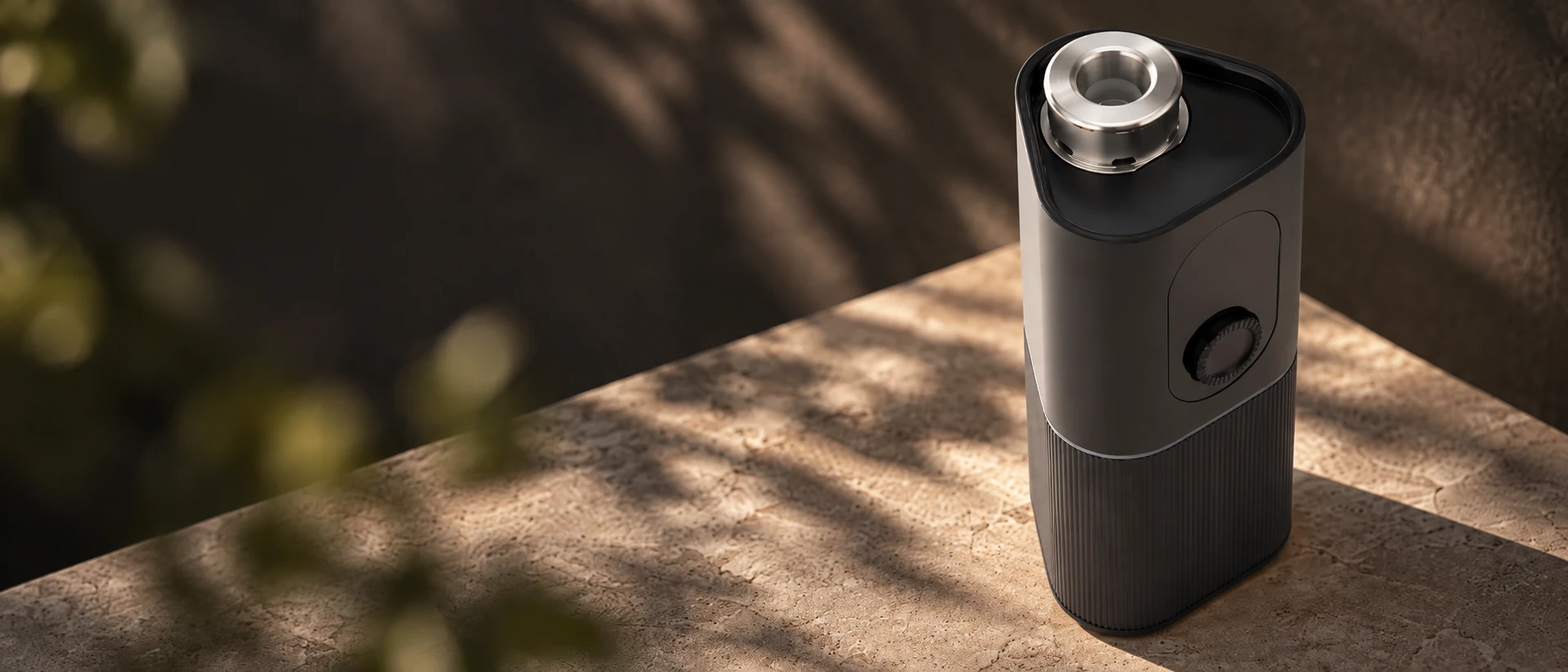 Graphite SparkIt TRI with its exposed metal heating chamber in naturally shaded limestone light